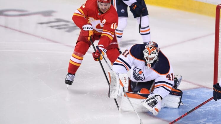 May 20, 2022; Calgary, Alberta, CAN; Calgary Flames forward Mikael Backlund (11) tries to score on Edmonton Oilers goalie Mike Smith (41) during the second period in game two of the second round of the 2022 Stanley Cup Playoffs at Scotiabank Saddledome. Mandatory Credit: Candice Ward-USA TODAY Sports