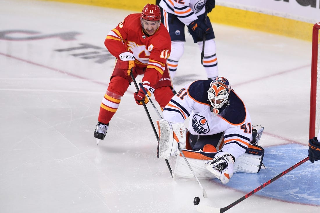 May 20, 2022; Calgary, Alberta, CAN; Calgary Flames forward Mikael Backlund (11) tries to score on Edmonton Oilers goalie Mike Smith (41) during the second period in game two of the second round of the 2022 Stanley Cup Playoffs at Scotiabank Saddledome. Mandatory Credit: Candice Ward-USA TODAY Sports