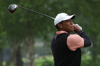 May 21, 2022; Tulsa, OK, USA; Tiger Woods plays his shot from the ninth tee as rain falls during the third round of the PGA Championship golf tournament at Southern Hills Country Club. Mandatory Credit: Michael Madrid-USA TODAY Sports