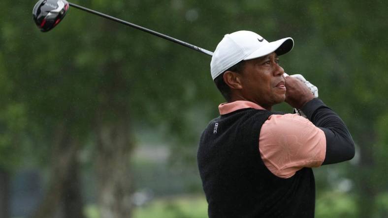 May 21, 2022; Tulsa, OK, USA; Tiger Woods plays his shot from the ninth tee as rain falls during the third round of the PGA Championship golf tournament at Southern Hills Country Club. Mandatory Credit: Michael Madrid-USA TODAY Sports