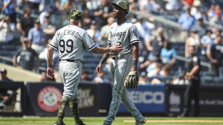 May 21, 2022; Bronx, New York, USA;  Chicago White Sox shortstop Tim Anderson (7) is held back by third base coach Joe McEwing (99) after the dugouts emptied in the fifth inning against the New York Yankees at Yankee Stadium. Mandatory Credit: Wendell Cruz-USA TODAY Sports