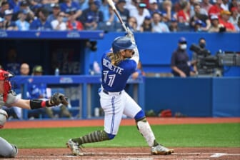 May 21, 2022; Toronto, Ontario, CAN; Toronto Blue Jays short stop Bo Bichette (11) hits a solo home run in the fourth inning against the Cincinnati Reds at Rogers Centre. Mandatory Credit: Gerry Angus-USA TODAY Sports
