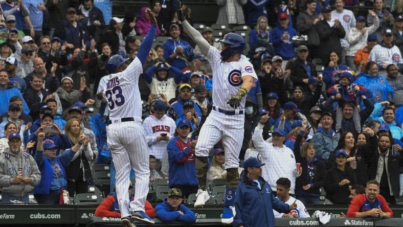 May 21, 2022; Chicago, Illinois, USA; Chicago Cubs third baseman Patrick Wisdom (16), high fives Chicago Cubs third base coach Willie Harris (33) after hitting a home run against the Arizona Diamondbacks during the second inning at Wrigley Field. Mandatory Credit: Matt Marton-USA TODAY Sports