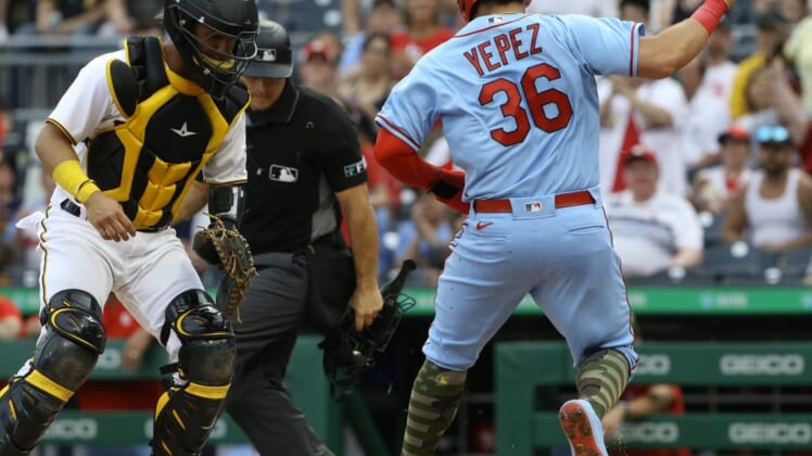 May 21, 2022; Pittsburgh, Pennsylvania, USA;  St. Louis Cardinals right fielder Juan Yepez (36) steps on home plate to score a run as Pittsburgh Pirates catcher Michael Perez (5) looks on during the second inning at PNC Park. Mandatory Credit: Charles LeClaire-USA TODAY Sports