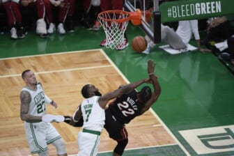 May 21, 2022; Boston, Massachusetts, USA; Boston Celtics guard Jaylen Brown (7) fouls Miami Heat forward Jimmy Butler (22) in the first half during game three of the 2022 eastern conference finals at TD Garden. Mandatory Credit: Bob DeChiara-USA TODAY Sports