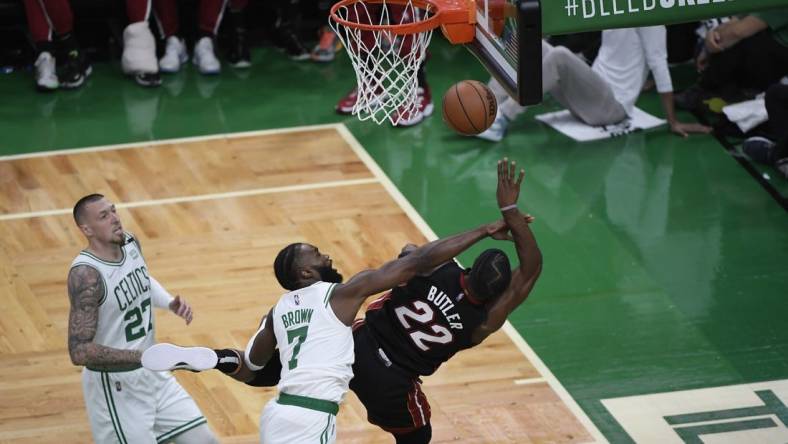 May 21, 2022; Boston, Massachusetts, USA; Boston Celtics guard Jaylen Brown (7) fouls Miami Heat forward Jimmy Butler (22) in the first half during game three of the 2022 eastern conference finals at TD Garden. Mandatory Credit: Bob DeChiara-USA TODAY Sports