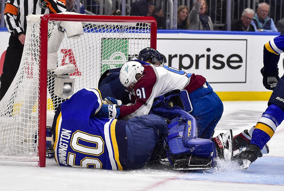 May 21, 2022; St. Louis, Missouri, USA; Colorado Avalanche center Nazem Kadri (91) collides with St. Louis Blues goaltender Jordan Binnington (50) during the first period in game three of the second round of the 2022 Stanley Cup Playoffs at Enterprise Center. Mandatory Credit: Jeff Curry-USA TODAY Sports