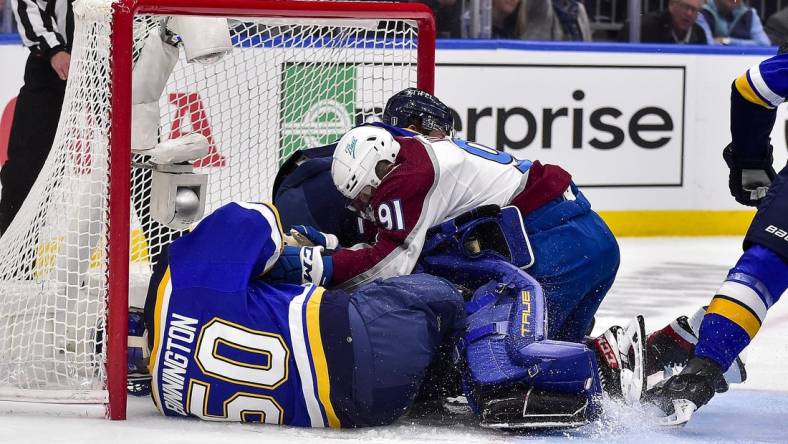 May 21, 2022; St. Louis, Missouri, USA; Colorado Avalanche center Nazem Kadri (91) collides with St. Louis Blues goaltender Jordan Binnington (50) during the first period in game three of the second round of the 2022 Stanley Cup Playoffs at Enterprise Center. Mandatory Credit: Jeff Curry-USA TODAY Sports