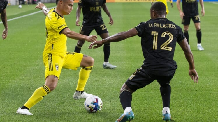 May 21, 2022; Columbus, Ohio, USA; Columbus Crew midfielder Lucas Zelarayan (10) cuts inside Los Angeles FC defender Diego Palacios (12) in the first half at Lower.com. Field Mandatory Credit: Greg Bartram-USA TODAY Sports