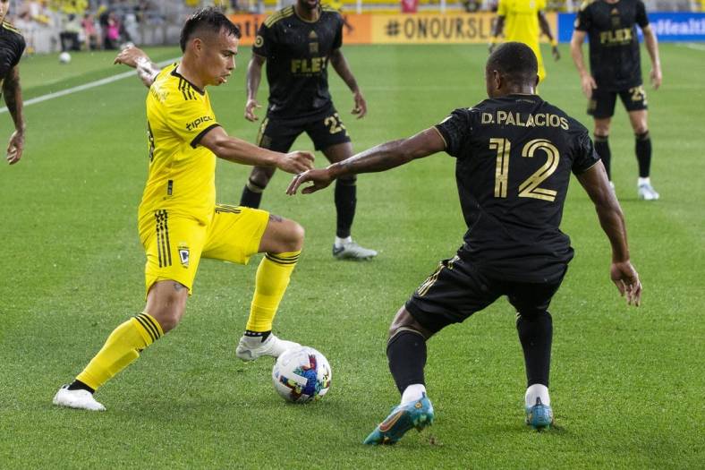 May 21, 2022; Columbus, Ohio, USA; Columbus Crew midfielder Lucas Zelarayan (10) cuts inside Los Angeles FC defender Diego Palacios (12) in the first half at Lower.com. Field Mandatory Credit: Greg Bartram-USA TODAY Sports