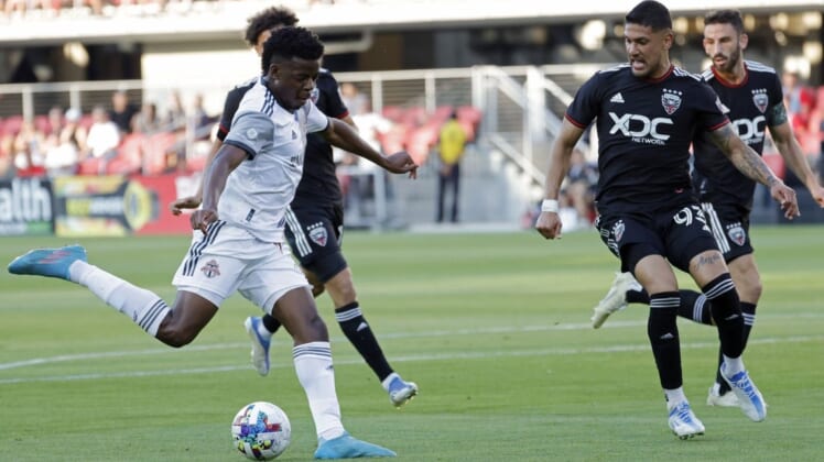May 21, 2022; Washington, District of Columbia, USA; Toronto FC forward Deandre Kerr (29) shoots the ball as D.C. United defender Tony Alfaro (93) defends in the first half at Audi Field. Mandatory Credit: Geoff Burke-USA TODAY Sports