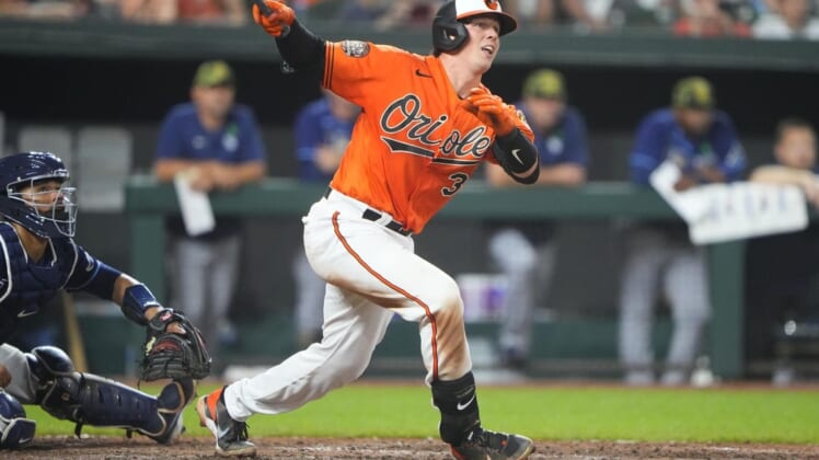May 21, 2022; Baltimore, Maryland, USA; Baltimore Orioles catcher Adley Rutschman (35) hits a triple for his first major league hit during the seventh inning against the Tampa Bay Rays at Oriole Park at Camden Yards. Mandatory Credit: Gregory Fisher-USA TODAY Sports
