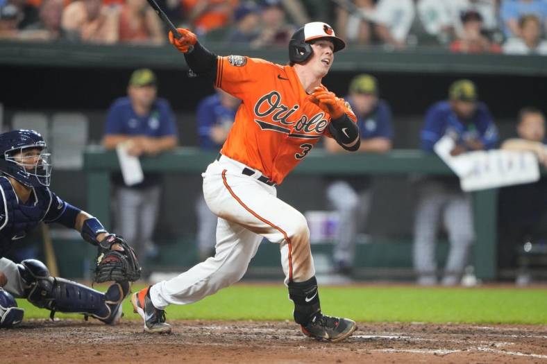 May 21, 2022; Baltimore, Maryland, USA; Baltimore Orioles catcher Adley Rutschman (35) hits a triple for his first major league hit during the seventh inning against the Tampa Bay Rays at Oriole Park at Camden Yards. Mandatory Credit: Gregory Fisher-USA TODAY Sports
