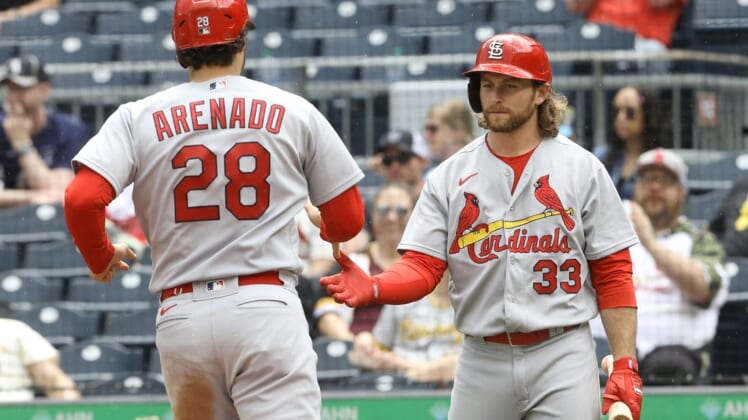 May 22, 2022; Pittsburgh, Pennsylvania, USA; St. Louis Cardinals right fielder Brendan Donovan (33) greets designated hitter Nolan Arenado (28) crossing home pate and scoring a run against the Pittsburgh Pirates during the fourth inning at PNC Park. Mandatory Credit: Charles LeClaire-USA TODAY Sports