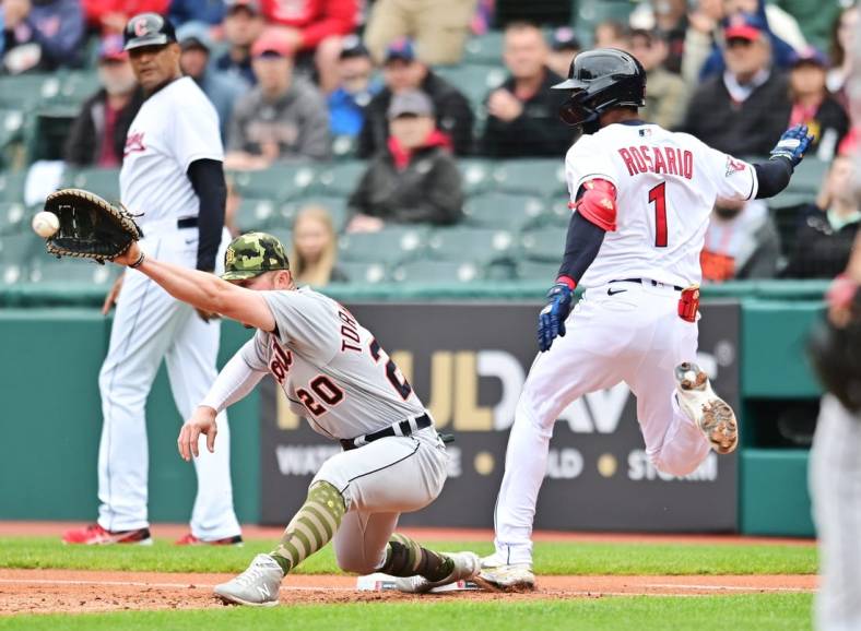 May 22, 2022; Cleveland, Ohio, USA; Cleveland Guardians left fielder Amed Rosario (1) is safe at first as Detroit Tigers first baseman Spencer Torkelson (20) waits for the throw during the first inning at Progressive Field. Mandatory Credit: Ken Blaze-USA TODAY Sports
