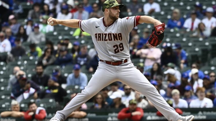 May 22, 2022; Chicago, Illinois, USA;  Arizona Diamondbacks starting pitcher Merrill Kelly (29) delivers against the Chicago Cubs during the first inning at Wrigley Field. Mandatory Credit: Matt Marton-USA TODAY Sports