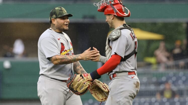 May 22, 2022; Pittsburgh, Pennsylvania, USA;  St. Louis Cardinals catchers Yadier Molina (left) and Andrew Knizner (right) celebrate after defeating the Pittsburgh Pirates at PNC Park. The Cardinals won 18-4. Mandatory Credit: Charles LeClaire-USA TODAY Sports
