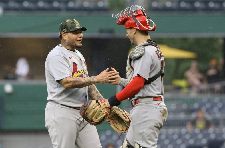 May 22, 2022; Pittsburgh, Pennsylvania, USA;  St. Louis Cardinals catchers Yadier Molina (left) and Andrew Knizner (right) celebrate after defeating the Pittsburgh Pirates at PNC Park. The Cardinals won 18-4. Mandatory Credit: Charles LeClaire-USA TODAY Sports