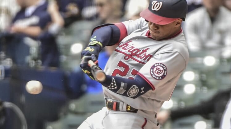 May 22, 2022; Milwaukee, Wisconsin, USA; Washington Nationals left fielder Juan Soto (22) hits a single to drive in two runs in the fourth inning during game against the Milwaukee Brewers at American Family Field. Mandatory Credit: Benny Sieu-USA TODAY Sports