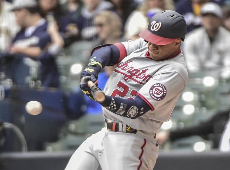 May 22, 2022; Milwaukee, Wisconsin, USA; Washington Nationals left fielder Juan Soto (22) hits a single to drive in two runs in the fourth inning during game against the Milwaukee Brewers at American Family Field. Mandatory Credit: Benny Sieu-USA TODAY Sports
