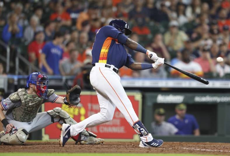 May 22, 2022; Houston, Texas, USA;  Houston Astros left fielder Yordan Alvarez (44) hits a RBI double against the Texas Rangers in the fifth inning at Minute Maid Park. Mandatory Credit: Thomas Shea-USA TODAY Sports
