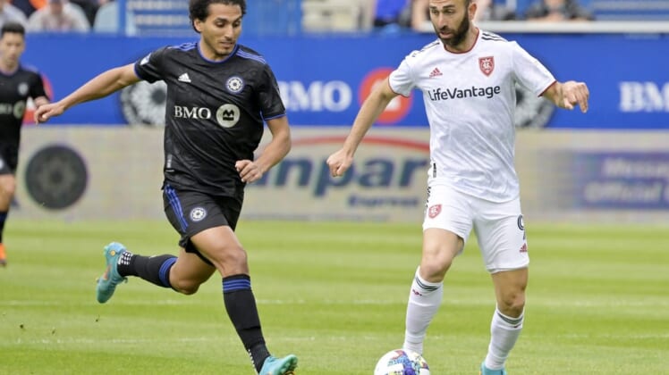 May 22, 2022; Montreal, Quebec, CAN;  Real Salt Lake forward Justin Meram (9) plays the ball and CF Montreal midfielder Ahmed Hamdi (7) defends during the first half at Stade Saputo. Mandatory Credit: Eric Bolte-USA TODAY Sports