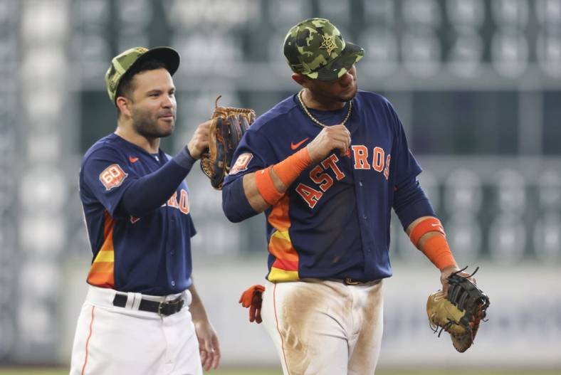 May 22, 2022; Houston, Texas, USA; Houston Astros second baseman Jose Altuve (27) messes around with  first baseman Yuli Gurriel (10) during a pitching change against the Texas Rangers  in the ninth inning at Minute Maid Park. Mandatory Credit: Thomas Shea-USA TODAY Sports