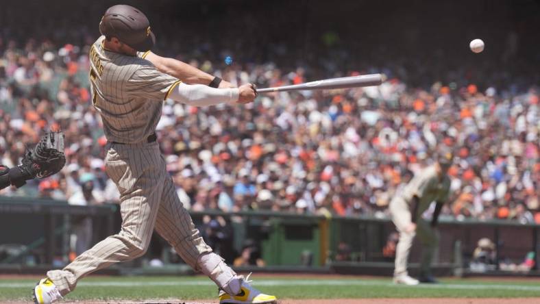 May 22, 2022; San Francisco, California, USA; San Diego Padres right fielder Wil Myers (5) hits an RBI double against the San Francisco Giants during the fourth inning at Oracle Park. Mandatory Credit: Darren Yamashita-USA TODAY Sports