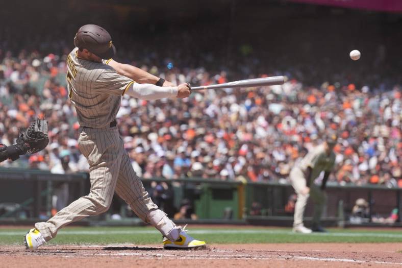 May 22, 2022; San Francisco, California, USA; San Diego Padres right fielder Wil Myers (5) hits an RBI double against the San Francisco Giants during the fourth inning at Oracle Park. Mandatory Credit: Darren Yamashita-USA TODAY Sports