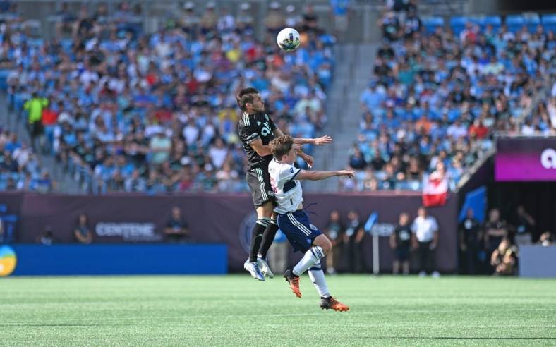 May 22, 2022; Charlotte, North Carolina, USA; Charlotte FC midfielder Brandt Bronico (13) heads the ball against Vancouver Whitecaps FC at Bank of America Stadium. Mandatory Credit: Griffin Zetterberg-USA TODAY Sports