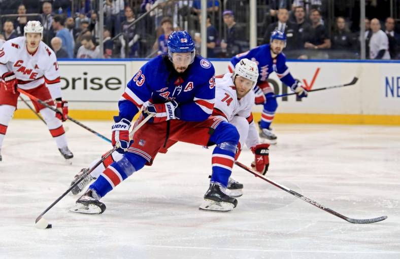 May 22, 2022; New York, New York, USA; New York Rangers center Mika Zibanejad (93) moves in against Carolina Hurricanes defenseman Jaccob Slavin (74) during the second period in game three of the second round of the 2022 Stanley Cup Playoffs at Madison Square Garden. Mandatory Credit: Danny Wild-USA TODAY Sports