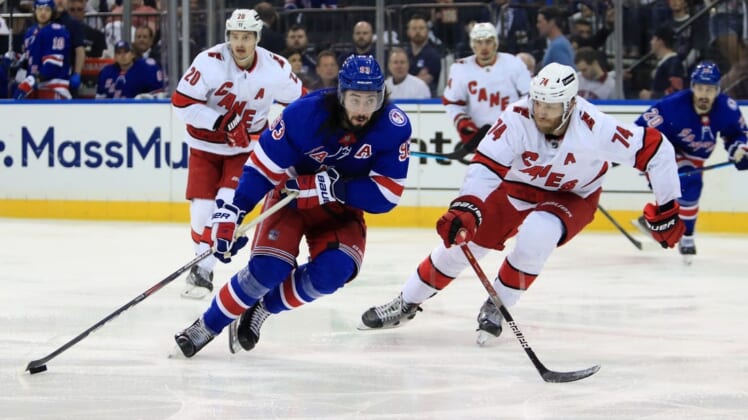 May 22, 2022; New York, New York, USA; New York Rangers center Mika Zibanejad (93) skates with the puck against Carolina Hurricanes defenseman Jaccob Slavin (74) during the second period in game three of the second round of the 2022 Stanley Cup Playoffs at Madison Square Garden. Mandatory Credit: Danny Wild-USA TODAY Sports