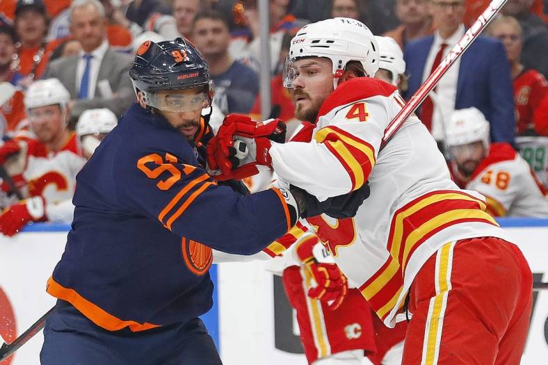 May 22, 2022; Edmonton, Alberta, CAN;Edmonton Oilers forward Evander Kane (91) battle for position with Calgary Flames defensemen Rasmus Andersson (4) during the first period in game three of the second round of the 2022 Stanley Cup Playoffs at Rogers Place. Mandatory Credit: Perry Nelson-USA TODAY Sports