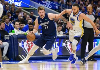 May 22, 2022; Dallas, Texas, USA; Dallas Mavericks guard Luka Doncic (77) drives to the basket past Golden State Warriors guard Stephen Curry (30) during the first quarter in game three of the 2022 western conference finals at American Airlines Center. Mandatory Credit: Jerome Miron-USA TODAY Sports