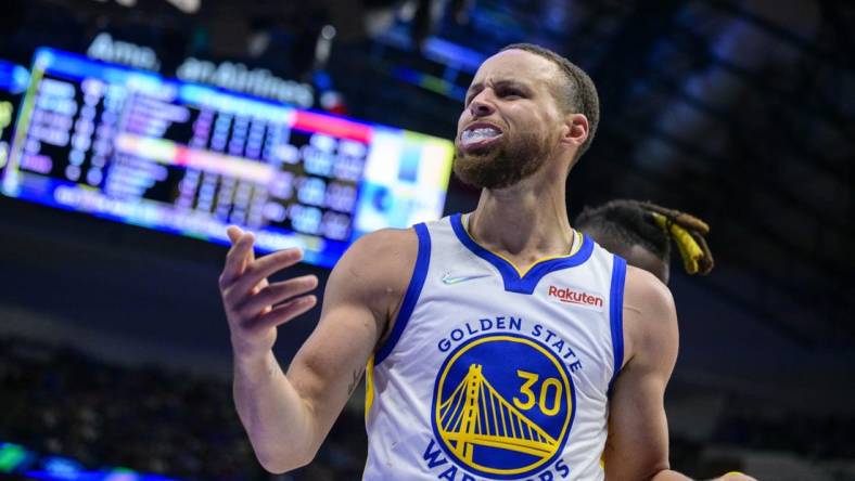 May 22, 2022; Dallas, Texas, USA; Golden State Warriors guard Stephen Curry (30) reacts to being fouled by Dallas Mavericks forward Reggie Bullock (25) during the third quarter in game three of the 2022 western conference finals at American Airlines Center. Mandatory Credit: Jerome Miron-USA TODAY Sports