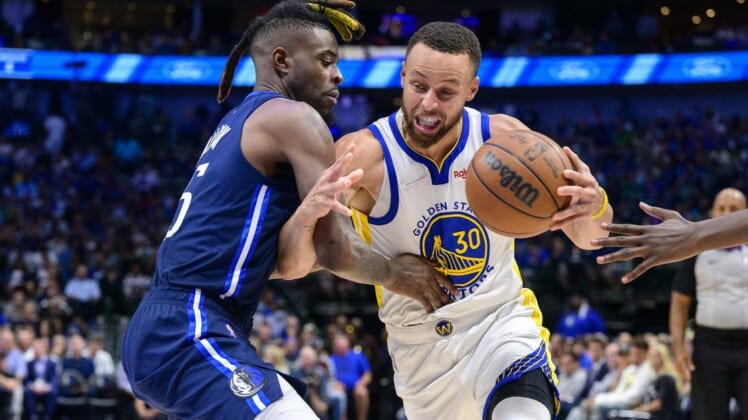 May 22, 2022; Dallas, Texas, USA; Golden State Warriors guard Stephen Curry (30) is fouled by Dallas Mavericks forward Reggie Bullock (25) during the third quarter in game three of the 2022 western conference finals at American Airlines Center. Mandatory Credit: Jerome Miron-USA TODAY Sports