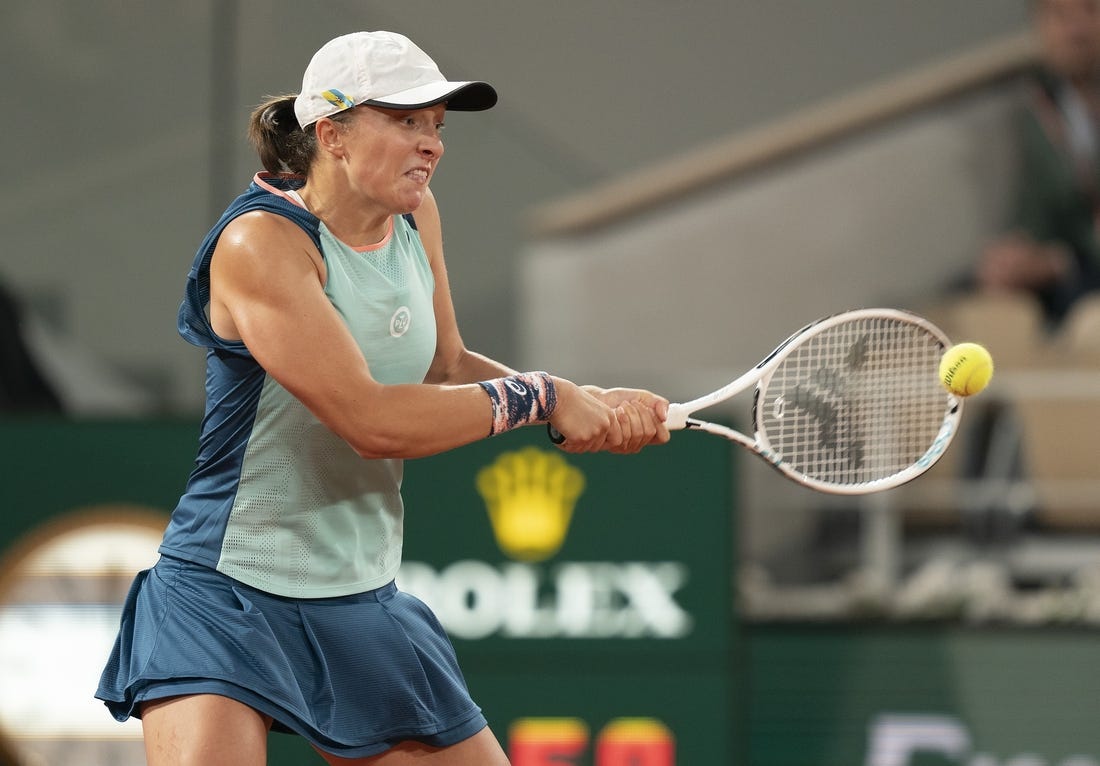 May 23, 2022; Paris, France; Iga Swiatek (POL) returns a shot during her match against Lesia Tsurenko (UKR) on day two of the French Open at Stade Roland-Garros.   Mandatory Credit: Susan Mullane-USA TODAY Sports