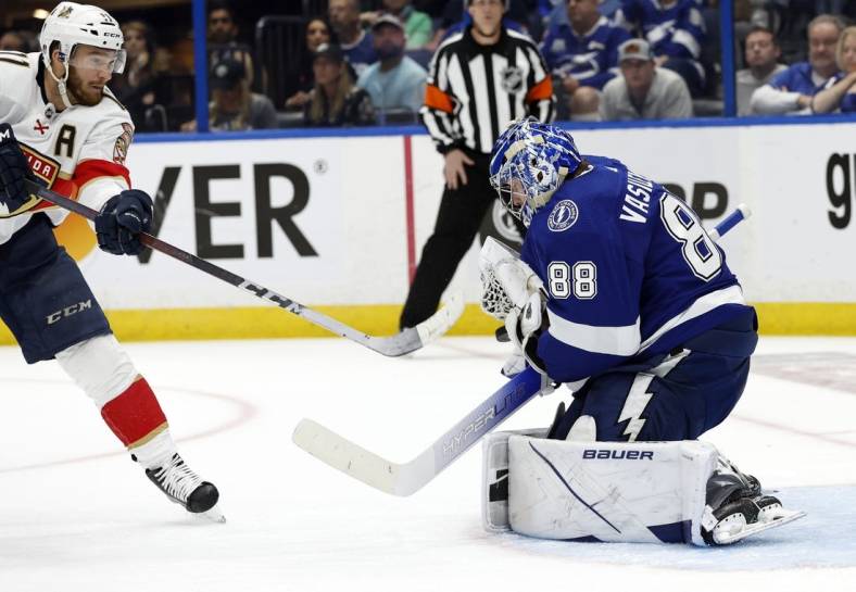 May 23, 2022; Tampa, Florida, USA;Tampa Bay Lightning goaltender Andrei Vasilevskiy (88) makes a save from Florida Panthers left wing Jonathan Huberdeau (11) during the second period at Amalie Arena. Mandatory Credit: Kim Klement-USA TODAY Sports