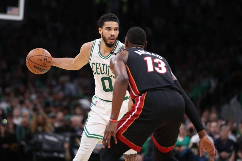 May 23, 2022; Boston, Massachusetts, USA; Boston Celtics forward Jayson Tatum (0) looks to move the ball defended by Miami Heat center Bam Adebayo (13) in the second half during game four of the 2022 eastern conference finals at TD Garden. Mandatory Credit: Paul Rutherford-USA TODAY Sports