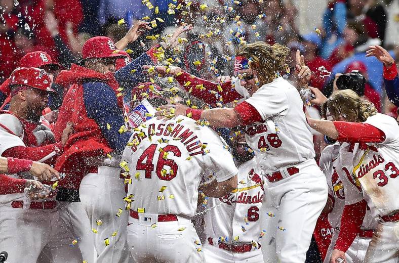 May 23, 2022; St. Louis, Missouri, USA;  St. Louis Cardinals first baseman Paul Goldschmidt (46) is congratulated by teammates at home plate after hitting a walk-off grand slam against the Toronto Blue Jays during the tenth inning at Busch Stadium. Mandatory Credit: Jeff Curry-USA TODAY Sports