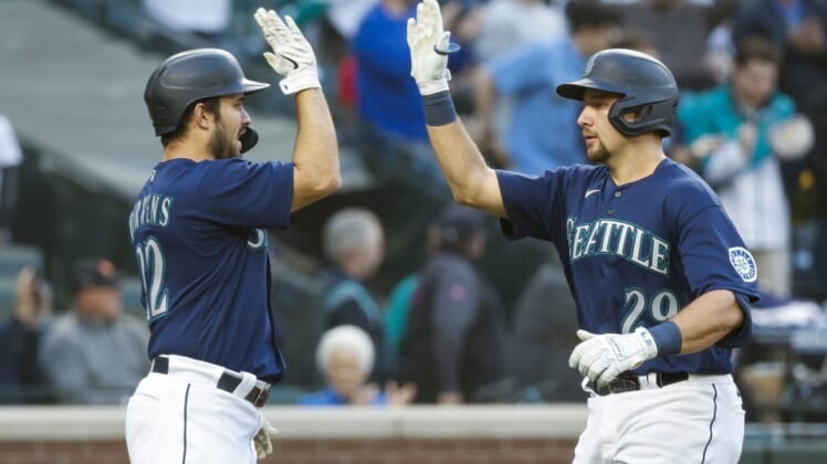 May 23, 2022; Seattle, Washington, USA; Seattle Mariners catcher Cal Raleigh (29) exchanges a high five with designated hitter Luis Torrens (22) after hitting a two-run home run against the Oakland Athletics during the fourth inning at T-Mobile Park. Mandatory Credit: Joe Nicholson-USA TODAY Sports