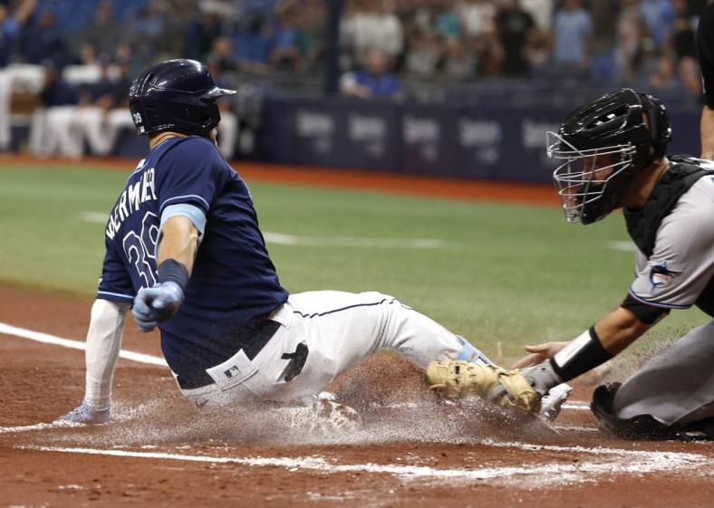 May 24, 2022; St. Petersburg, Florida, USA; Tampa Bay Rays center fielder Kevin Kiermaier (39) slides home to score a run on a in the park home run during the first inning against the Miami Marlins at Tropicana Field. Mandatory Credit: Kim Klement-USA TODAY Sports