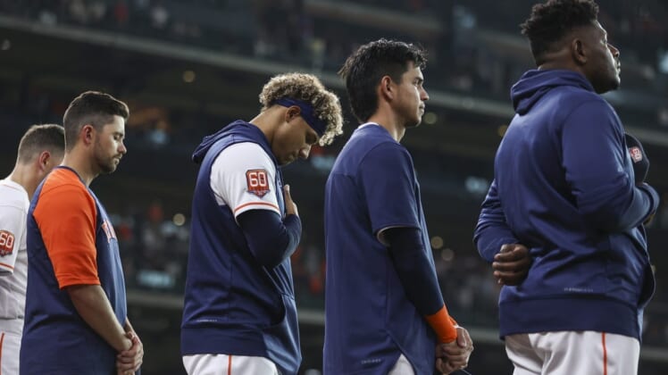 May 24, 2022; Houston, Texas, USA; Houston Astros players stand in a moment of silence for the victims of the school shooting in Uvalde, Texas before the game against the Cleveland Guardians at Minute Maid Park. Mandatory Credit: Troy Taormina-USA TODAY Sports