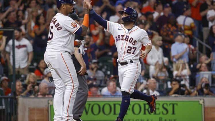 May 24, 2022; Houston, Texas, USA; Houston Astros second baseman Jose Altuve (27) celebrates with catcher Martin Maldonado (15) after scoring a run during the third inning against the Cleveland Guardians at Minute Maid Park. Mandatory Credit: Troy Taormina-USA TODAY Sports