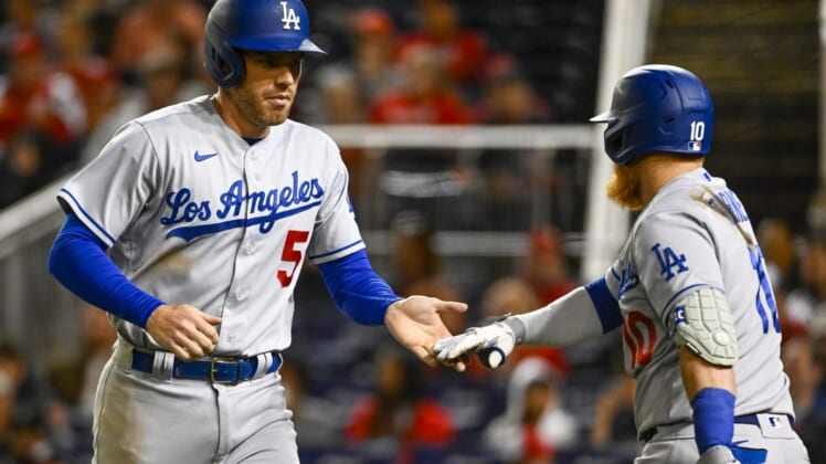 May 24, 2022; Washington, District of Columbia, USA; Los Angeles Dodgers first baseman Freddie Freeman (5) is congratulated by third baseman Justin Turner (10) after scoring during the sixth inning at Nationals Park. Mandatory Credit: Brad Mills-USA TODAY Sports