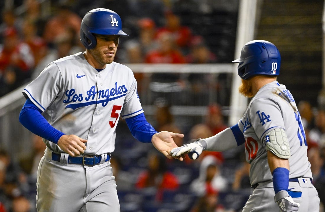 May 24, 2022; Washington, District of Columbia, USA; Los Angeles Dodgers first baseman Freddie Freeman (5) is congratulated by third baseman Justin Turner (10) after scoring during the sixth inning at Nationals Park. Mandatory Credit: Brad Mills-USA TODAY Sports