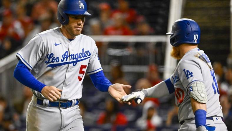 May 24, 2022; Washington, District of Columbia, USA; Los Angeles Dodgers first baseman Freddie Freeman (5) is congratulated by third baseman Justin Turner (10) after scoring during the sixth inning at Nationals Park. Mandatory Credit: Brad Mills-USA TODAY Sports