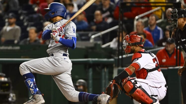May 24, 2022; Washington, District of Columbia, USA; Los Angeles Dodgers right fielder Mookie Betts (50) hits a single against the Washington Nationals during the sixth inning at Nationals Park. Mandatory Credit: Brad Mills-USA TODAY Sports
