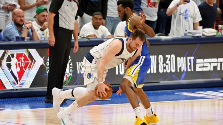 May 24, 2022; Dallas, Texas, USA; Dallas Mavericks guard Luka Doncic (77) dribbles the ball against Golden State Warriors forward Andrew Wiggins (22) during the fourth quarter in game four of the 2022 Western Conference finals at American Airlines Center. Mandatory Credit: Kevin Jairaj-USA TODAY Sports