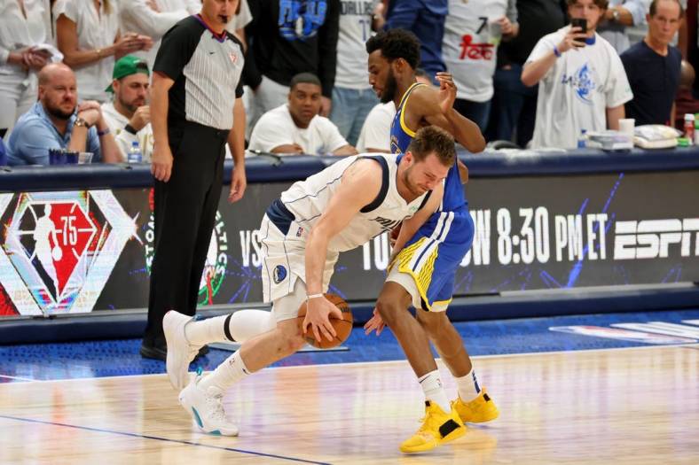 May 24, 2022; Dallas, Texas, USA; Dallas Mavericks guard Luka Doncic (77) dribbles the ball against Golden State Warriors forward Andrew Wiggins (22) during the fourth quarter in game four of the 2022 Western Conference finals at American Airlines Center. Mandatory Credit: Kevin Jairaj-USA TODAY Sports